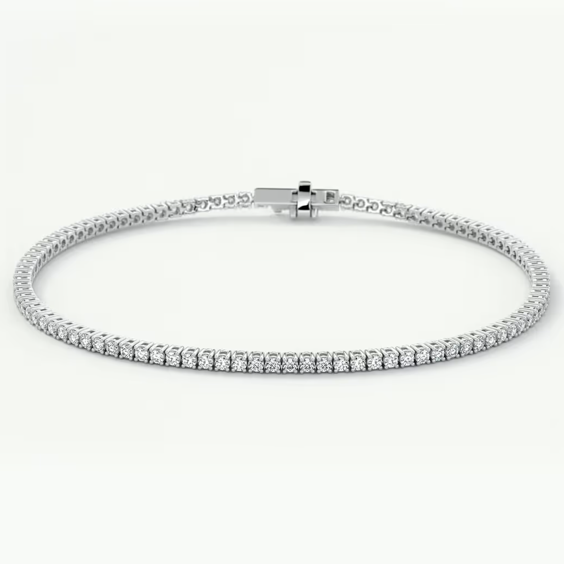 A white gold tennis bracelet with a continuous row of clear round-cut gemstones, displayed on a clean white background.