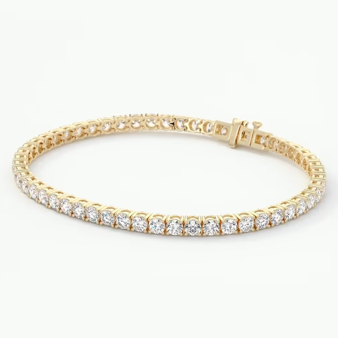 A yellow gold tennis bracelet set with round-cut clear gemstones, displayed on a clean white background.