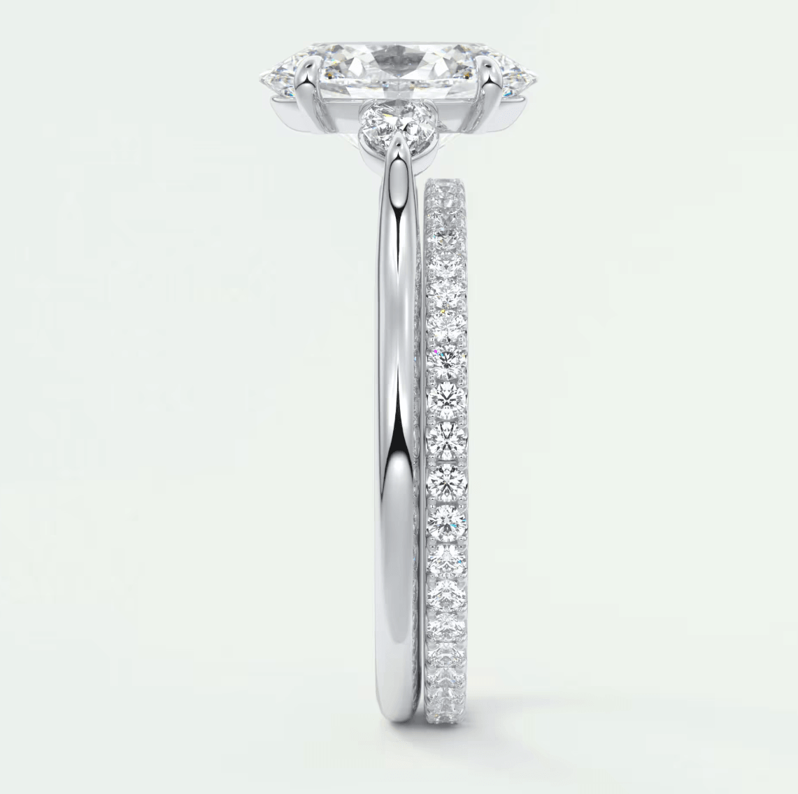 18-karat white gold engagement ring with a cushion-cut diamond center stone and pavé-set diamonds on the band.