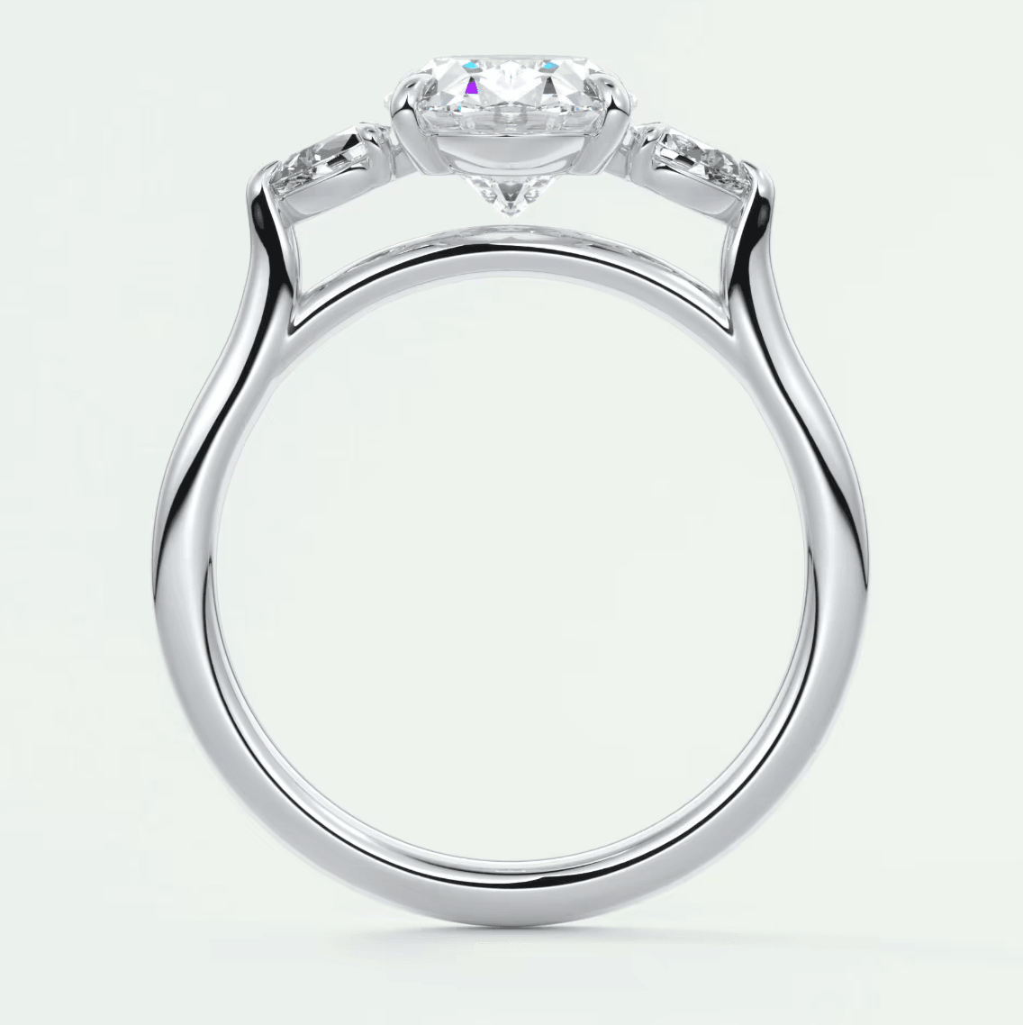 White gold engagement ring with a large central diamond and smaller diamonds on the band, featuring an elegant halo design.