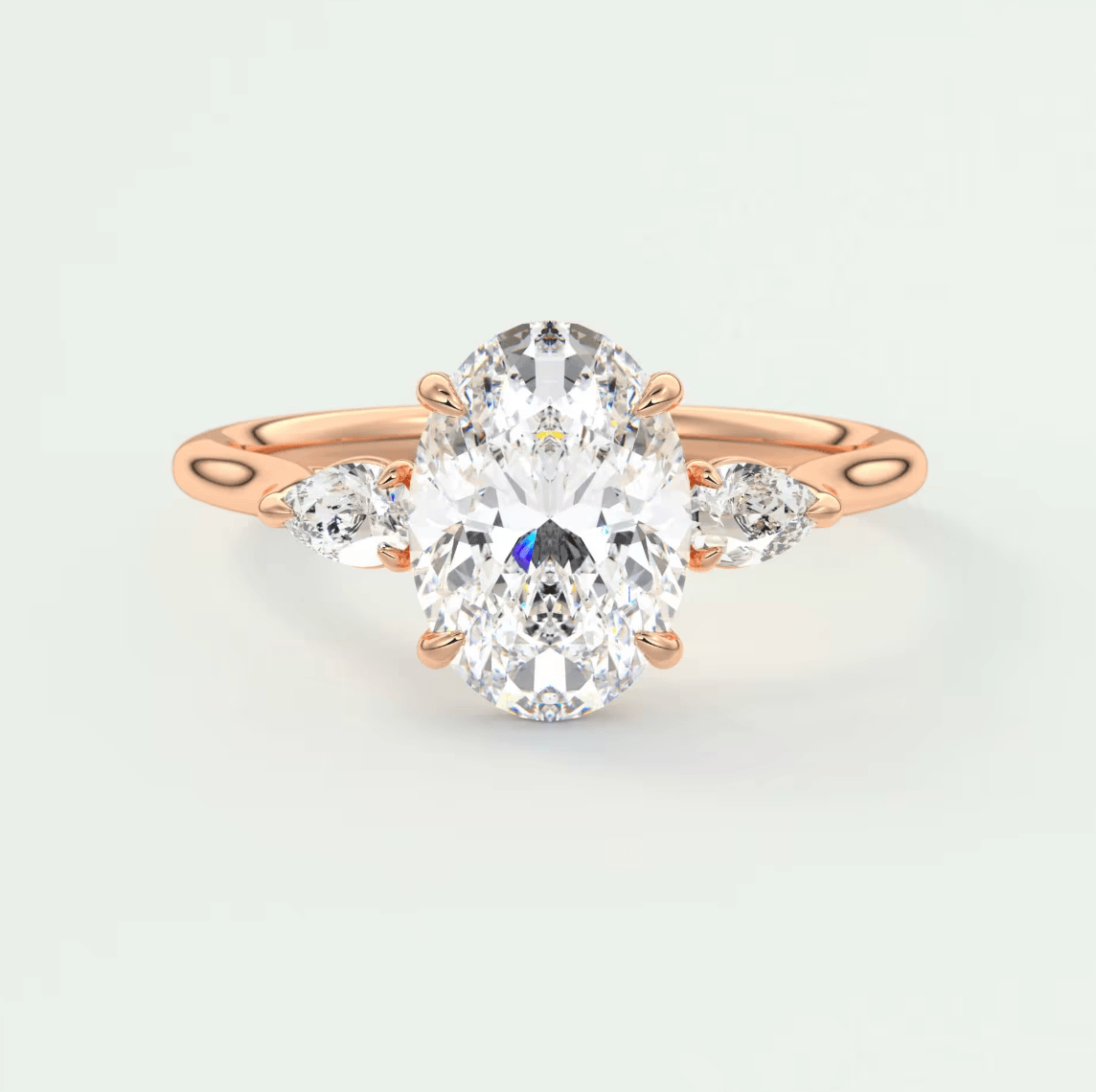 Rose gold diamond engagement ring with an oval center stone and marquise side stones.