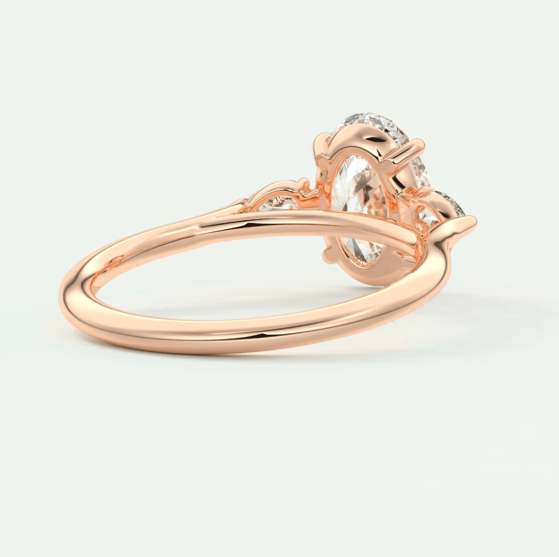 Rose gold diamond engagement ring with floral detailing and a central round-cut stone.