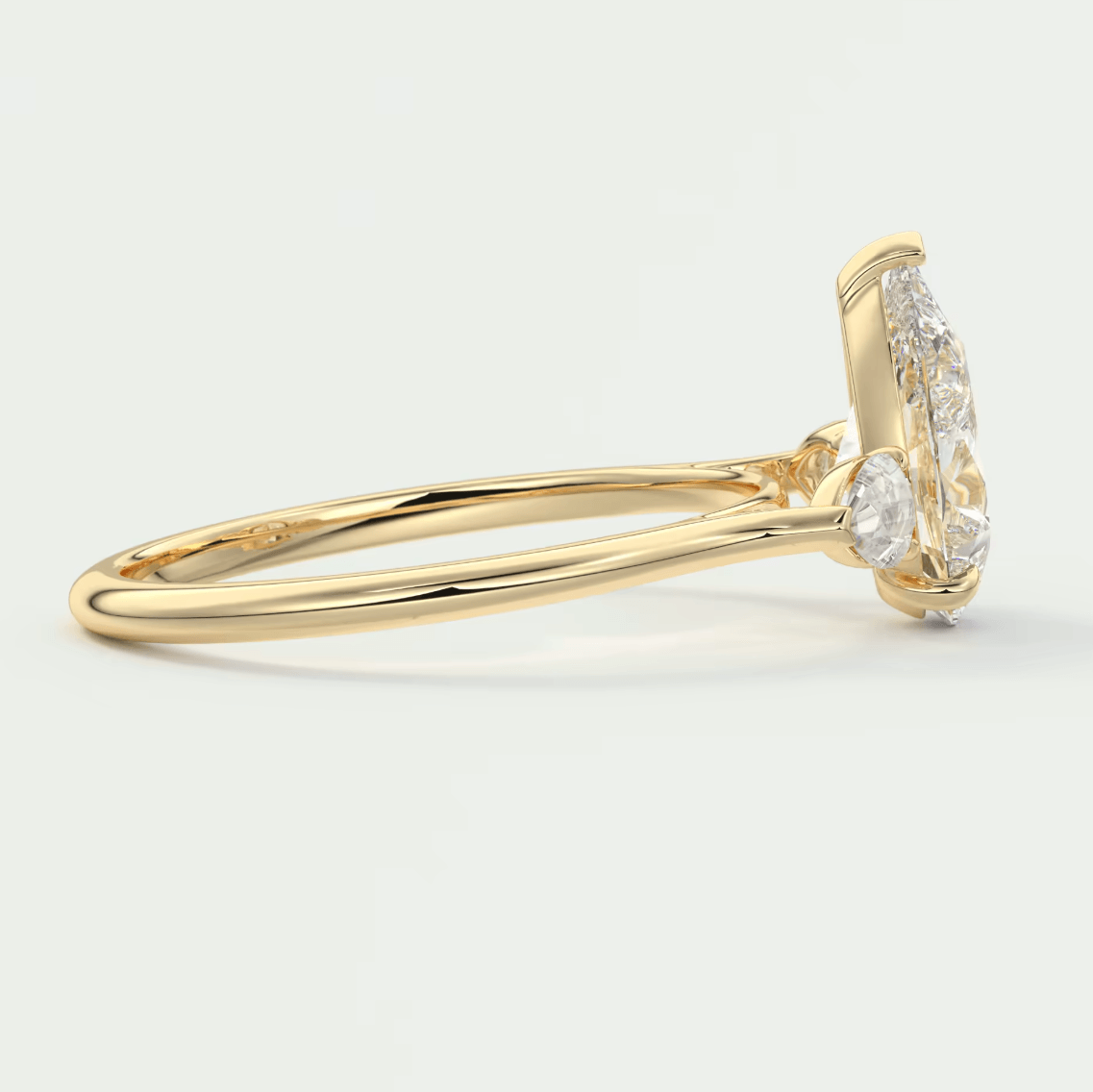 18k yellow gold diamond engagement ring with a marquise-cut center stone and halo of smaller diamonds.
