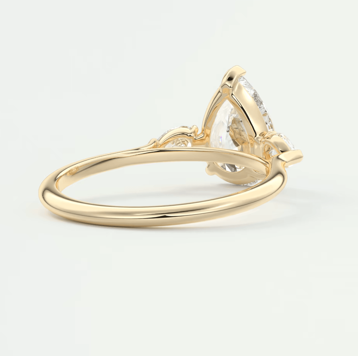 18k yellow gold engagement ring with a pear-shaped diamond.