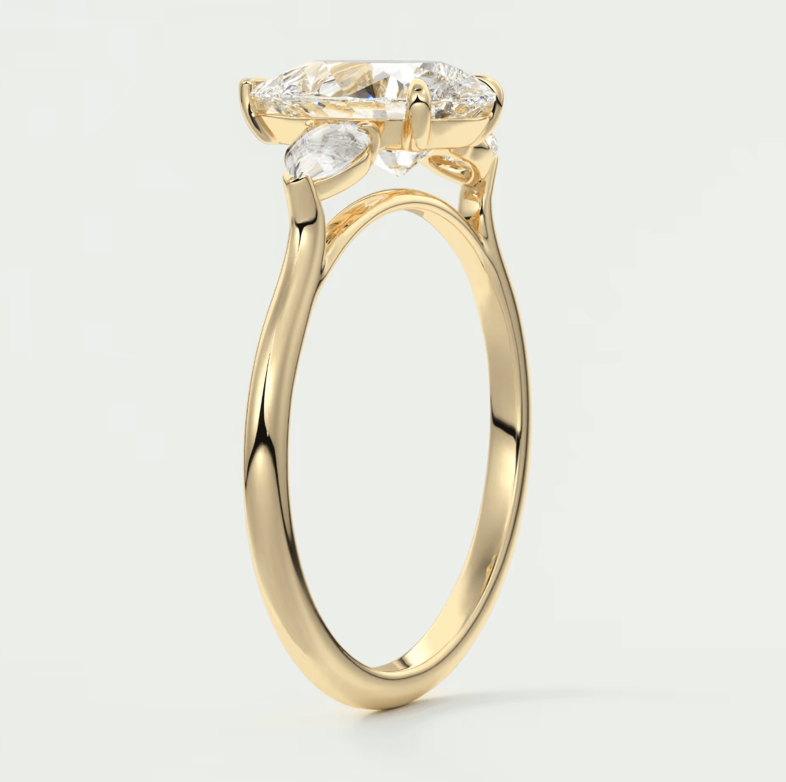 Yellow gold engagement ring with marquise-cut diamond and smaller diamonds on the band.