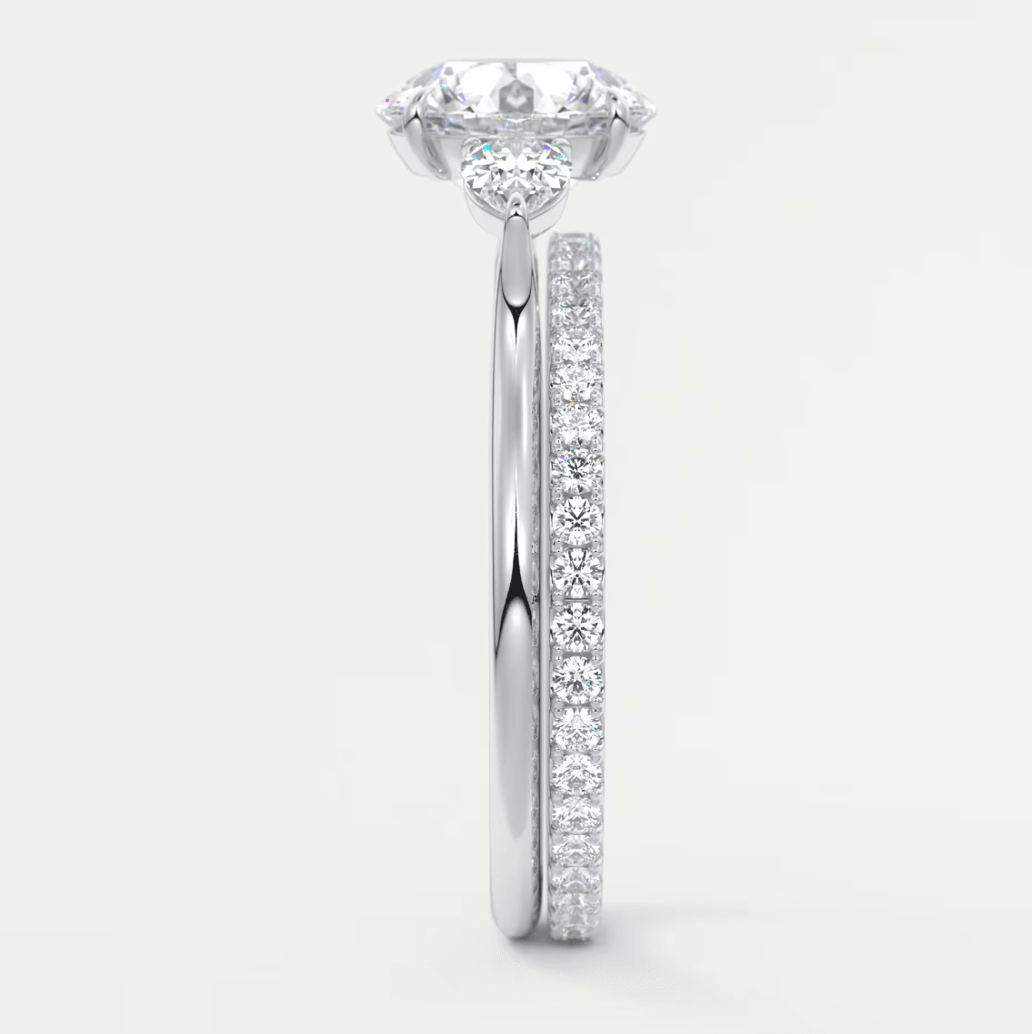 18-karat white gold engagement ring with a round diamond center and pavé set diamonds on the band.