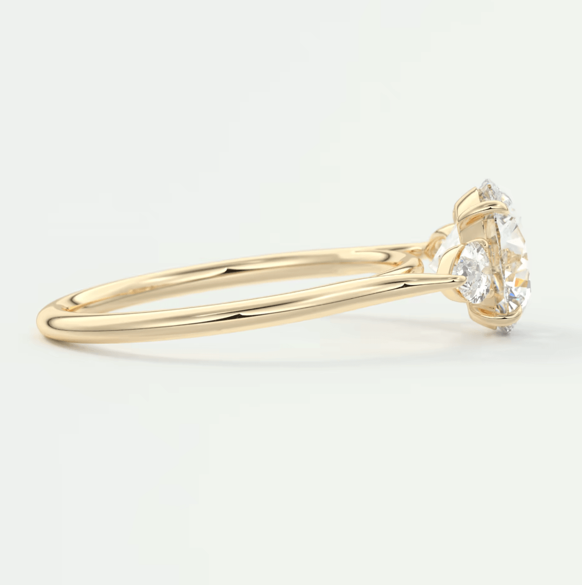 18k yellow gold diamond engagement ring with a round-cut center stone and four prongs.