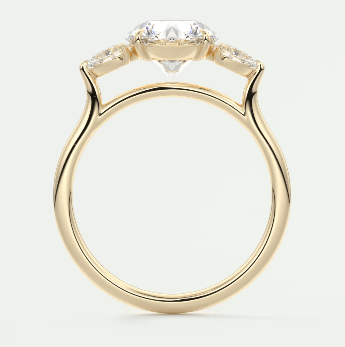 18-karat yellow gold engagement ring with a marquise-cut diamond and two smaller diamonds on either side.