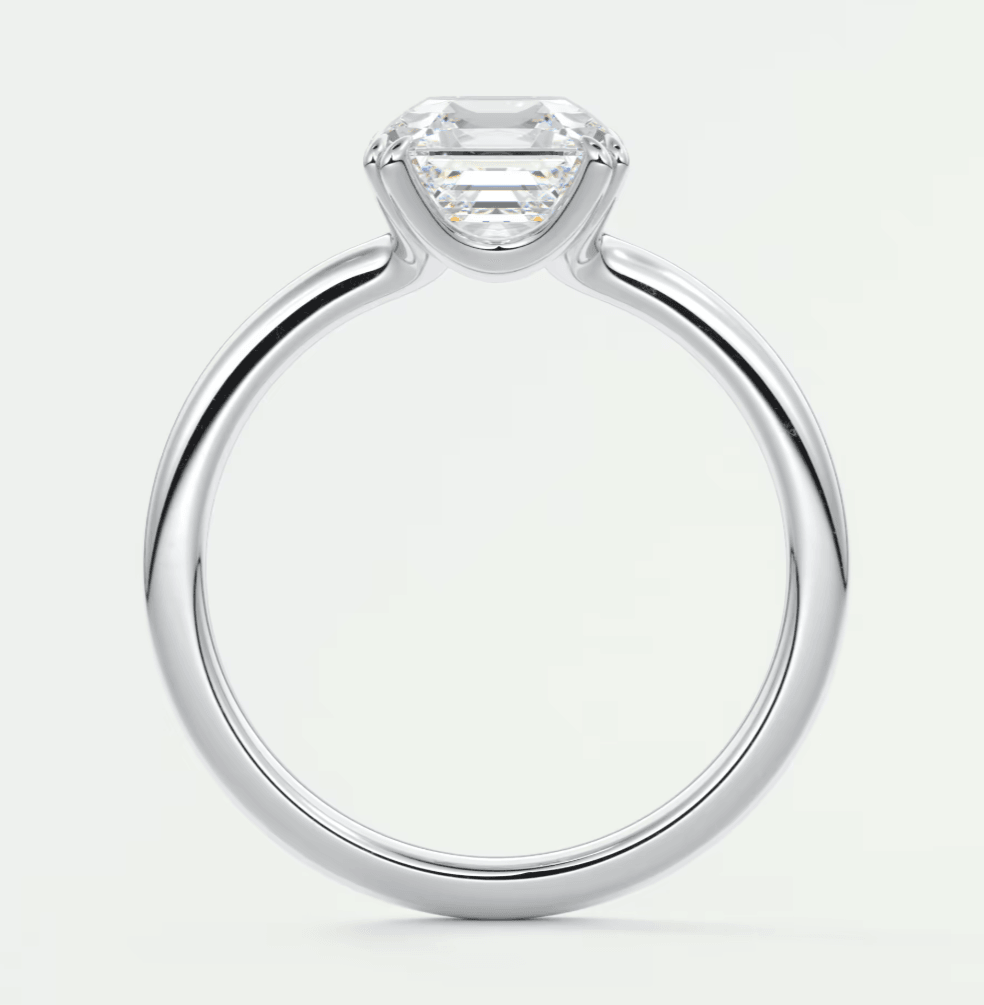18-karat white gold engagement ring with an emerald-cut diamond.