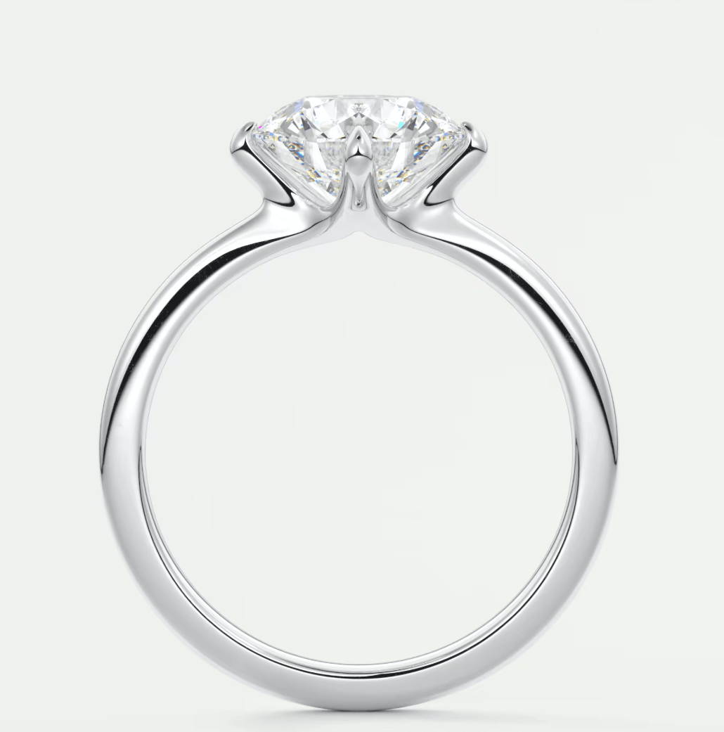 Silver solitaire diamond engagement ring with a classic four-prong setting.