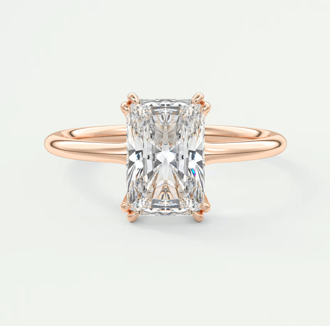 Rose gold diamond engagement ring with a rectangular cut gemstone.