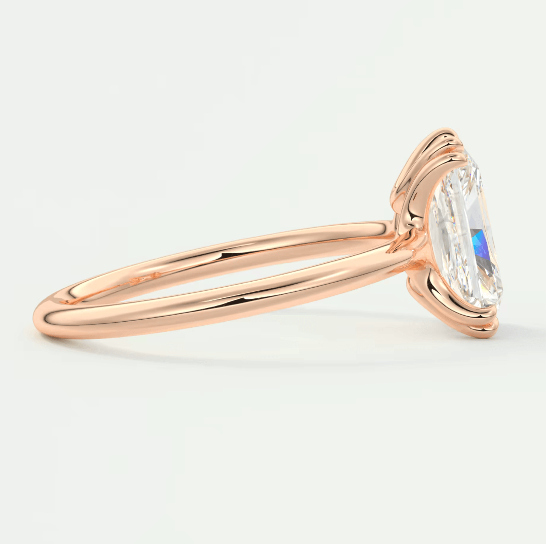 18k rose gold engagement ring with a marquise-cut diamond.