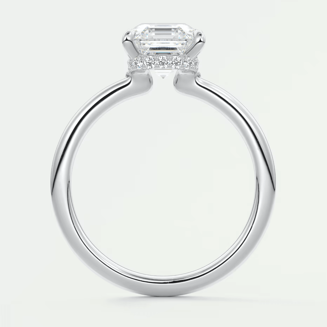 18k white gold emerald cut diamond engagement ring with a halo of smaller diamonds.