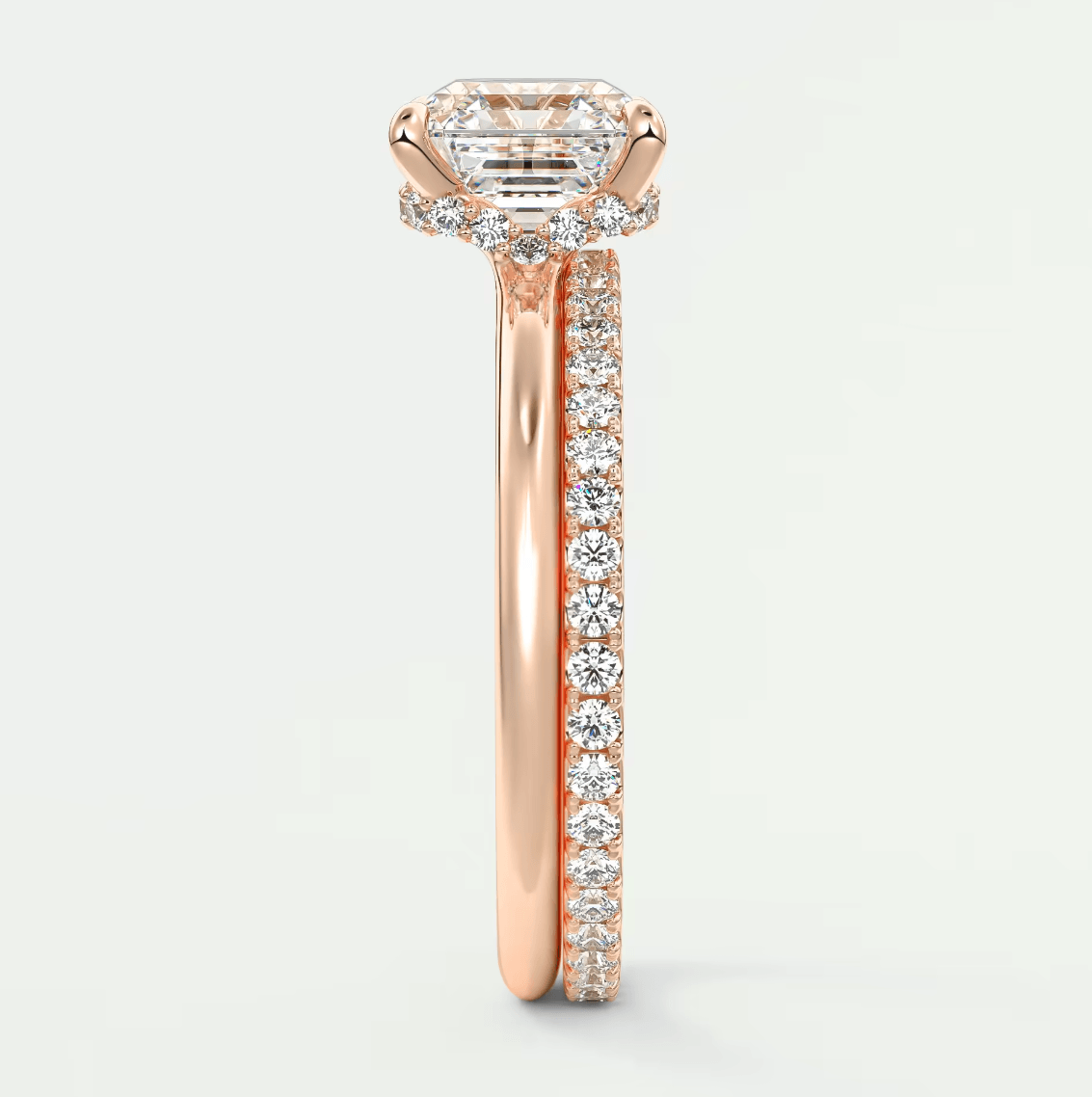 18-karat rose gold engagement ring with a princess-cut diamond center stone and pavé-set diamonds on the band.