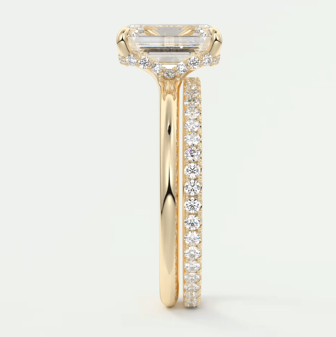 18k yellow gold engagement ring with a princess cut diamond and pavé set diamonds on the band.