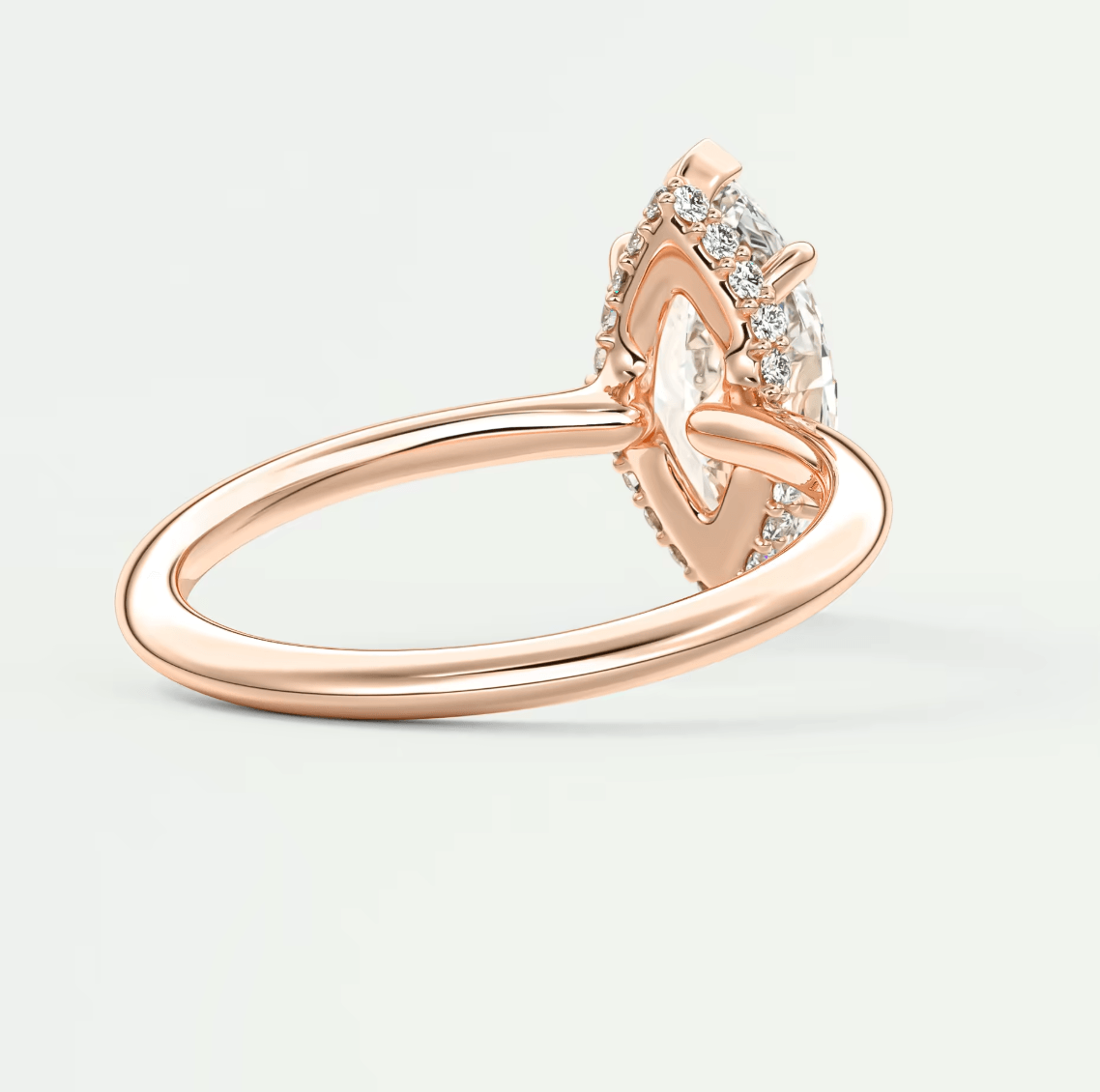 Rose gold heart-shaped diamond engagement ring with a marquise-cut center stone and small diamonds set in the band.