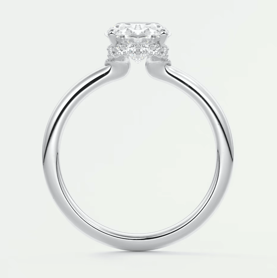 White gold engagement ring with a central diamond and smaller diamonds on the band, featuring a classic solitaire design.