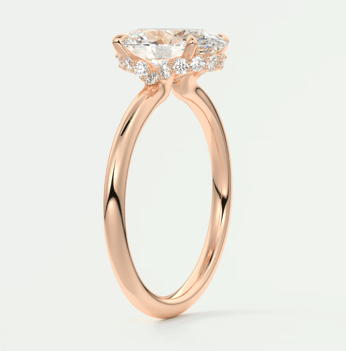 Rose gold engagement ring with a large central diamond and smaller diamonds on the band, featuring an elegant halo design.