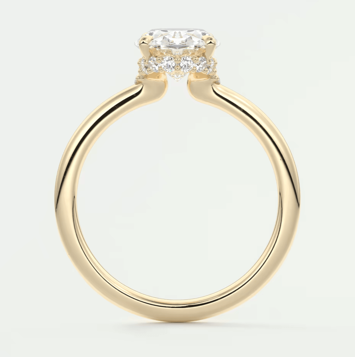 18-karat yellow gold engagement ring with a cushion-cut diamond and smaller diamonds set in the band.