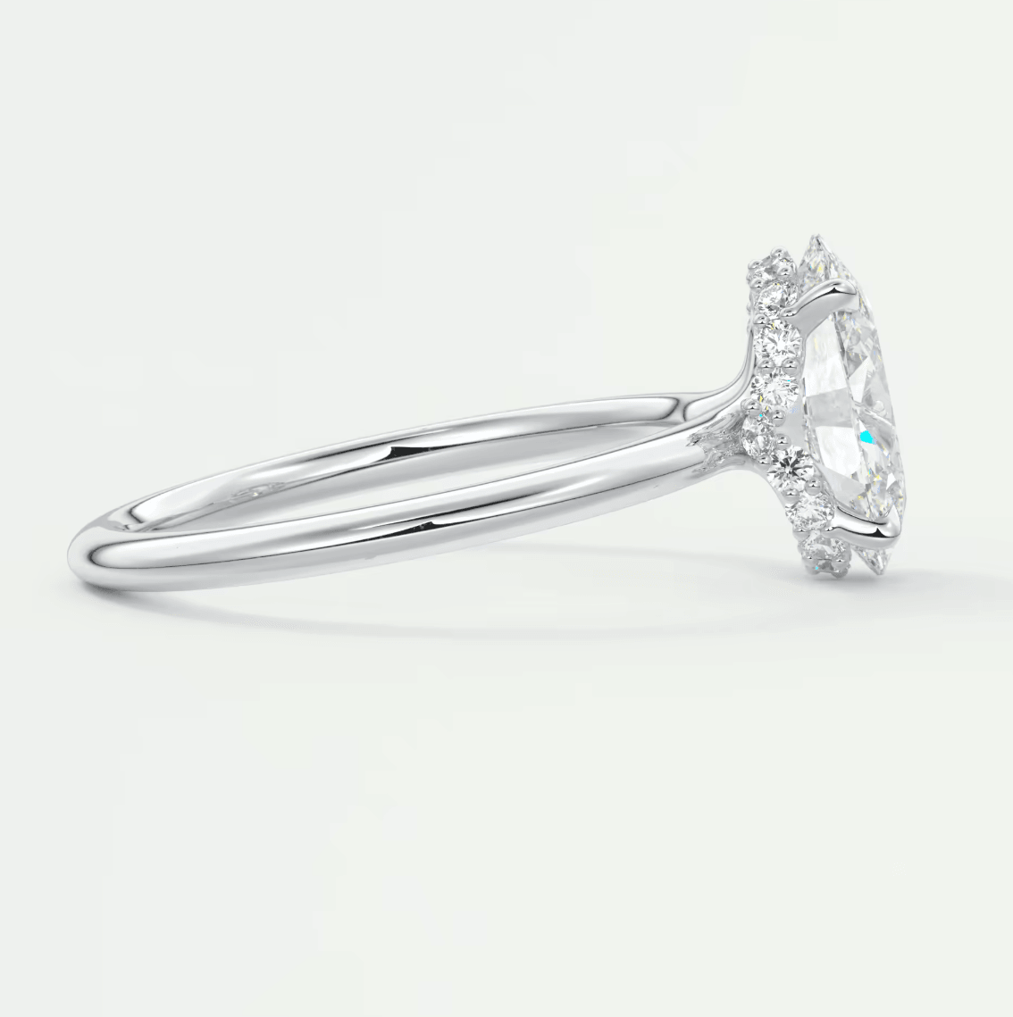 18k white gold diamond engagement ring with a marquise-cut center stone and halo of smaller diamonds.