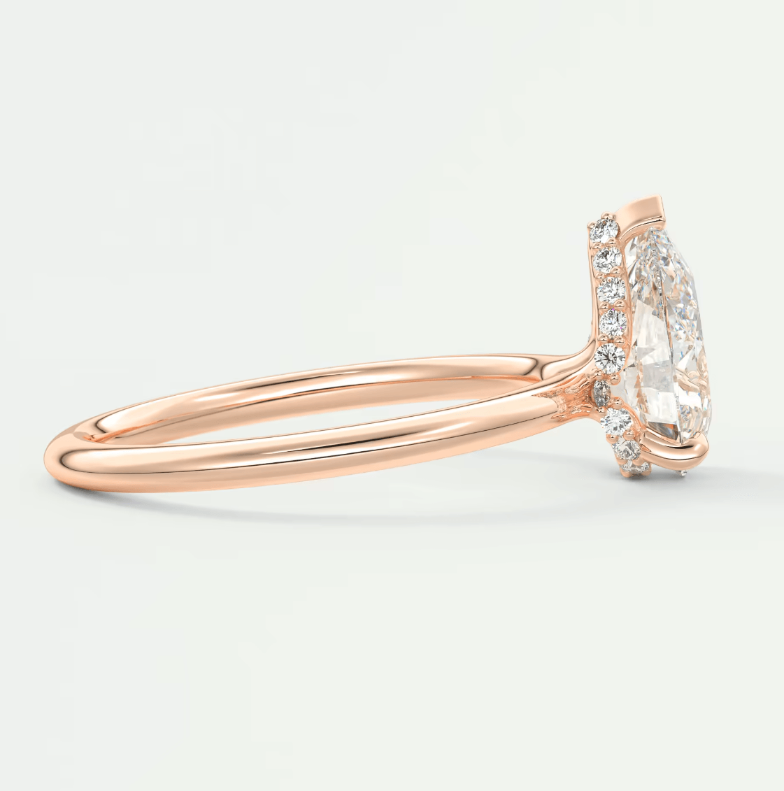 Rose gold diamond engagement ring with halo design and pave set diamonds on band