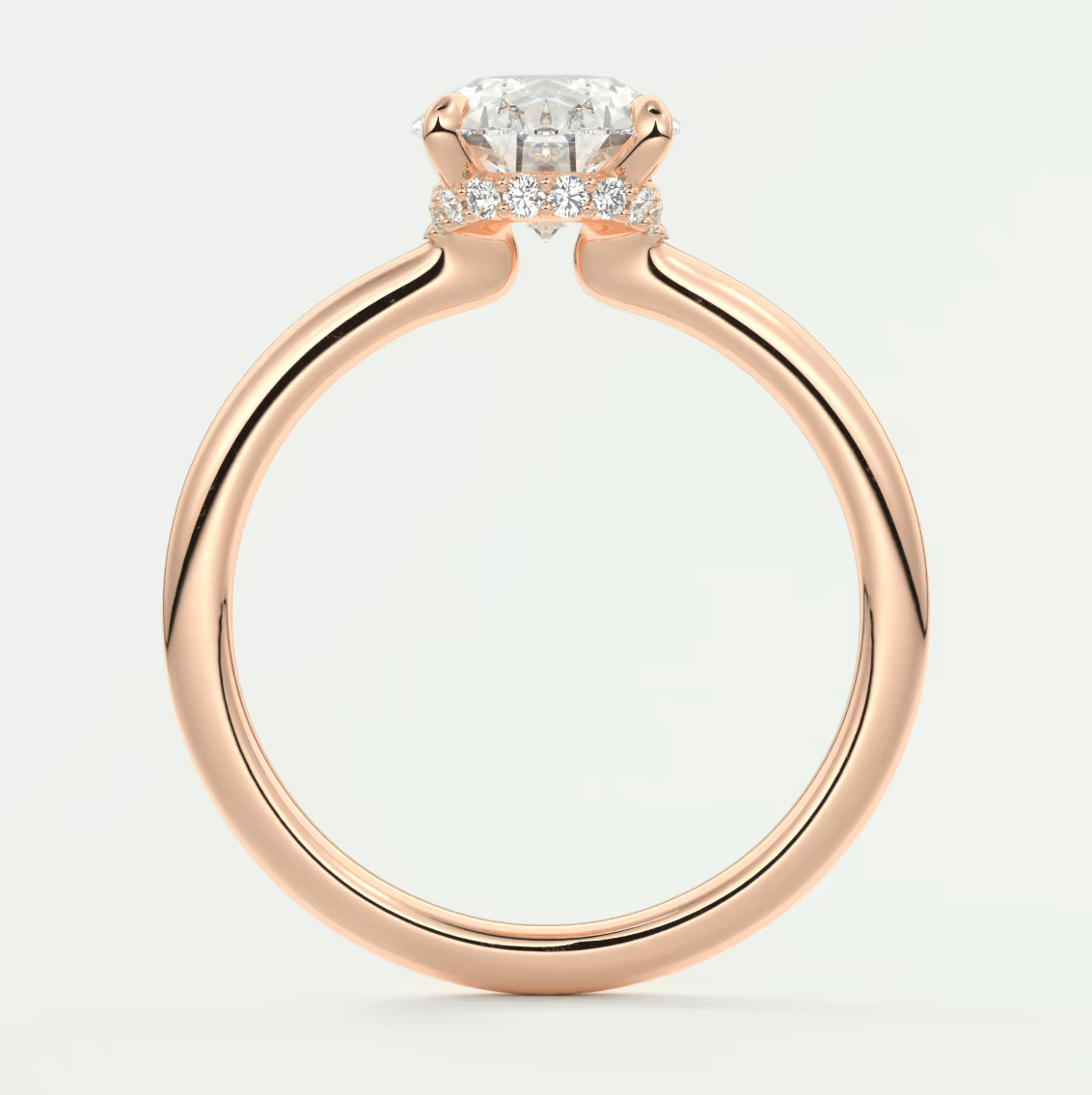 Rose gold diamond engagement ring with a cushion-cut center stone and small diamonds on the band.