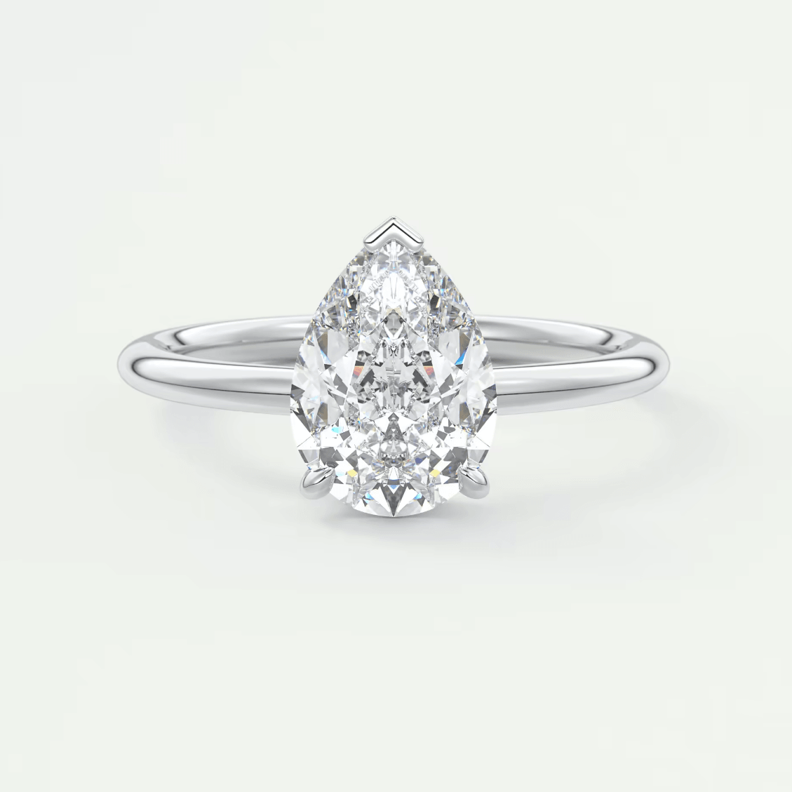 Pear-shaped diamond engagement ring with white gold band, featuring a classic solitaire design.