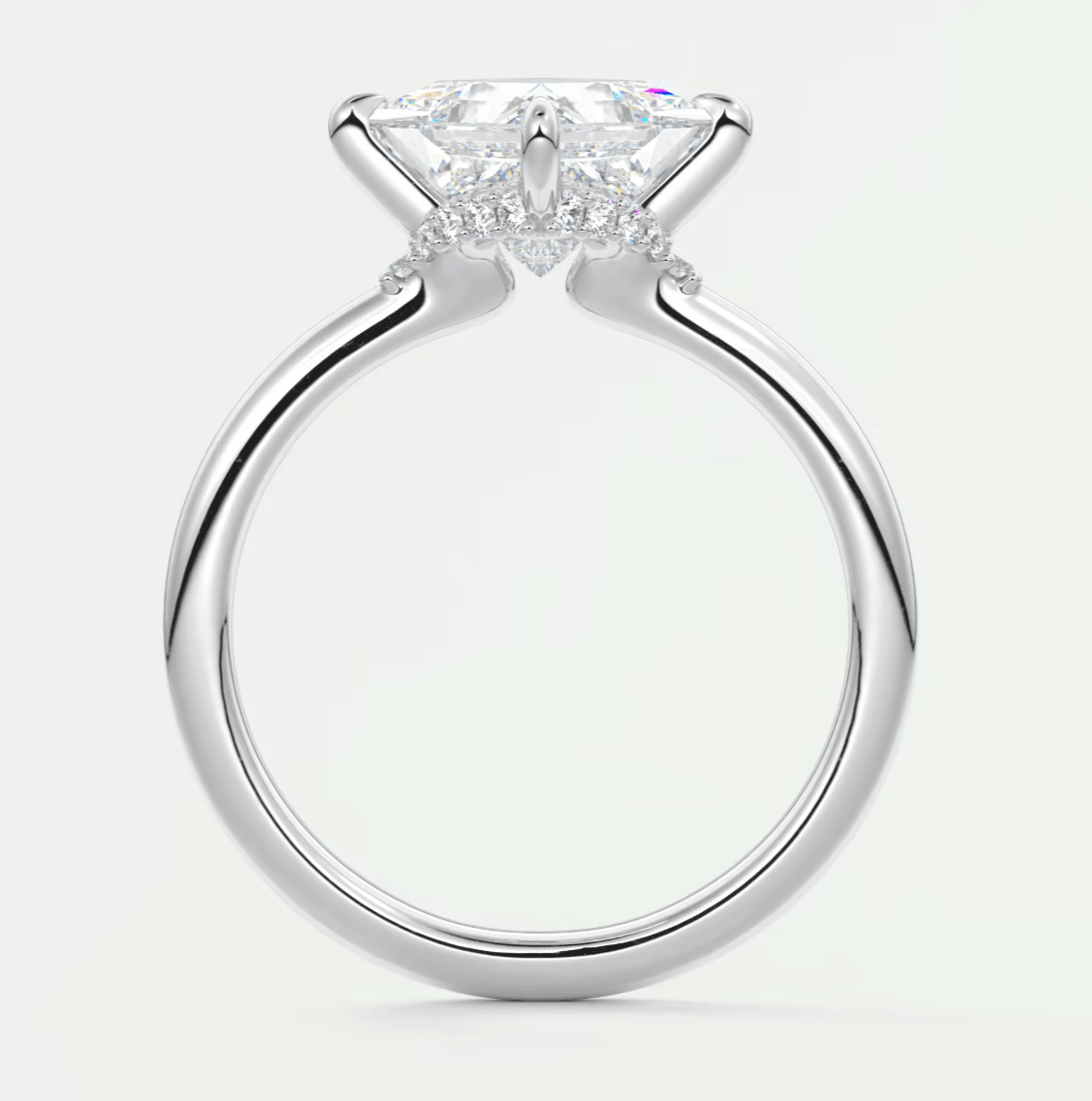 White gold engagement ring with a marquise-cut diamond and halo of smaller diamonds.