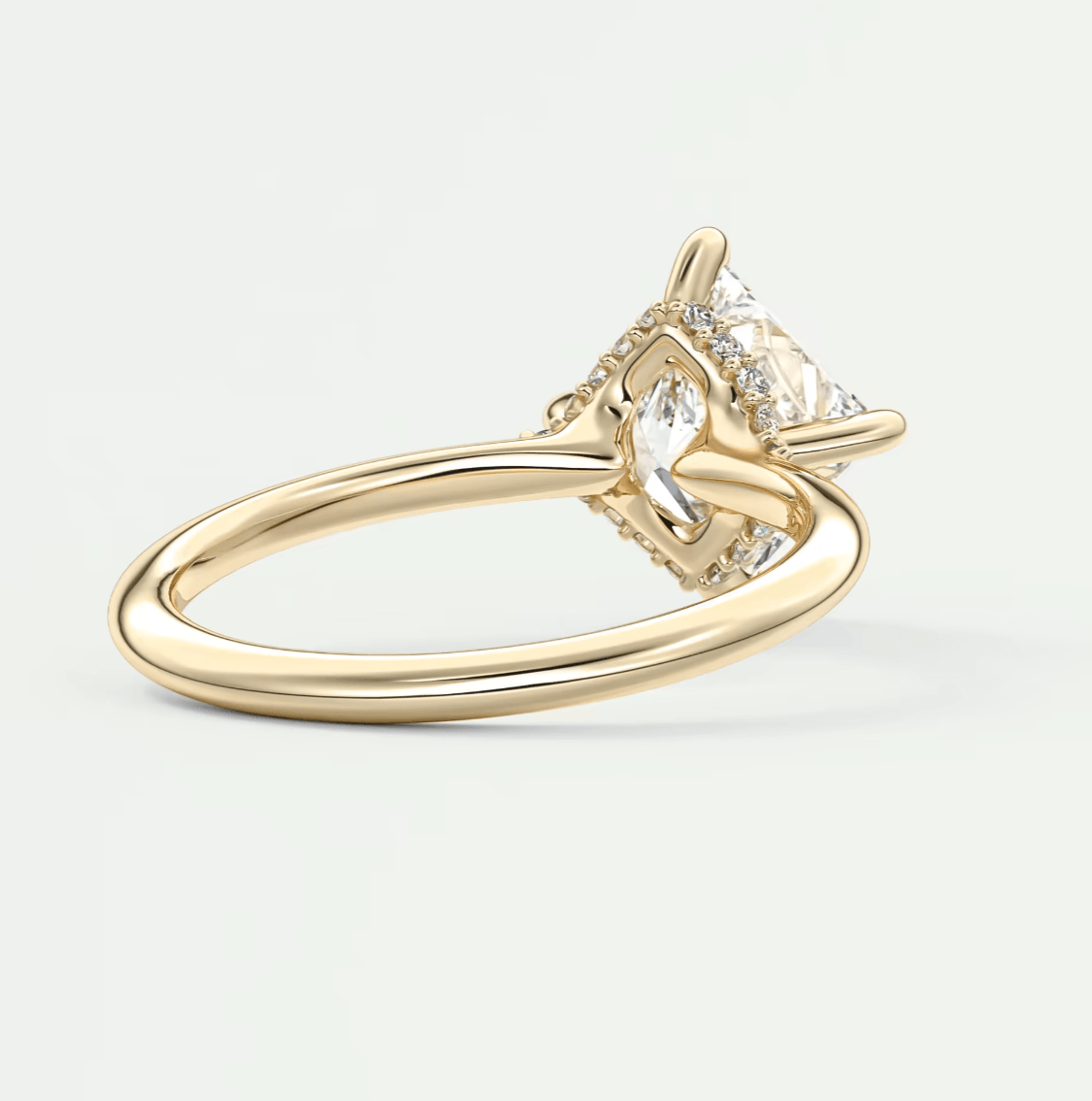 18k gold engagement ring with a marquise-cut diamond and smaller diamonds set in the band.