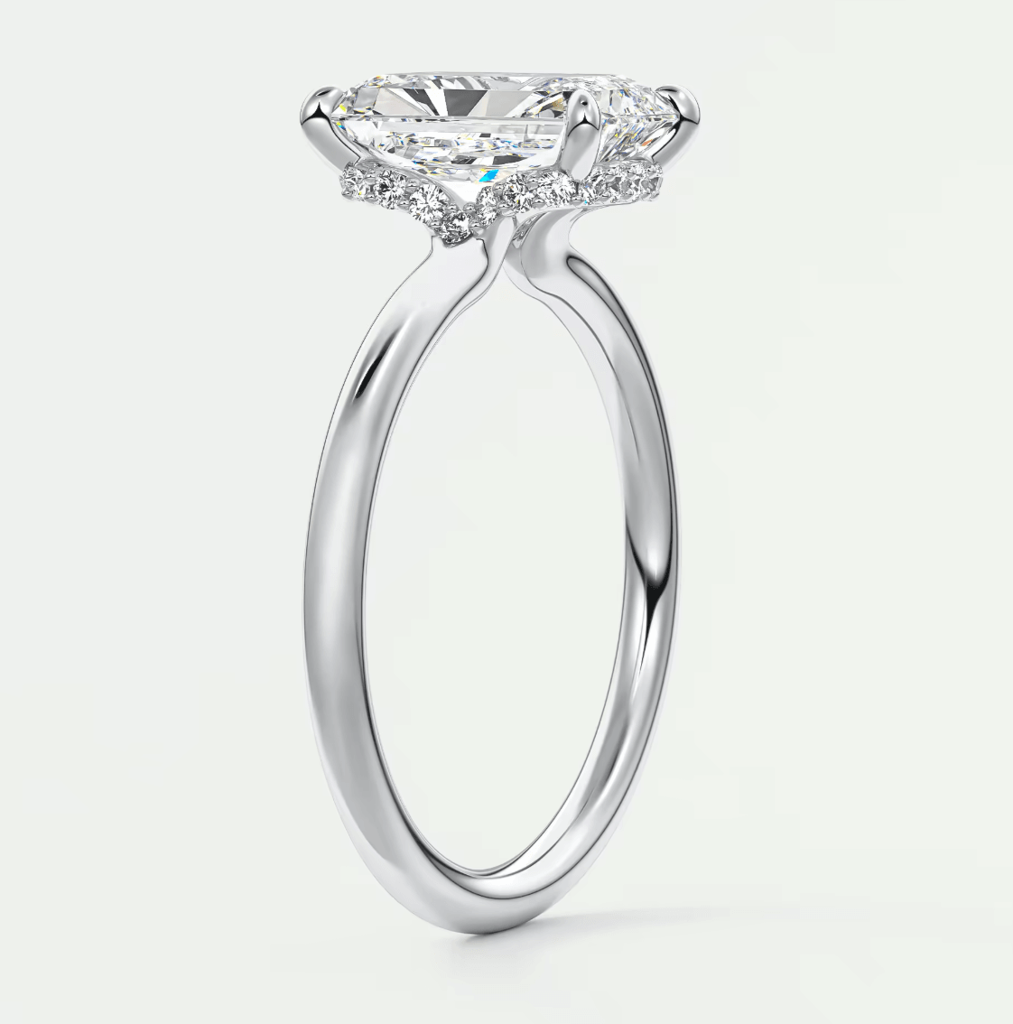 18-karat white gold engagement ring with a cushion-cut diamond.