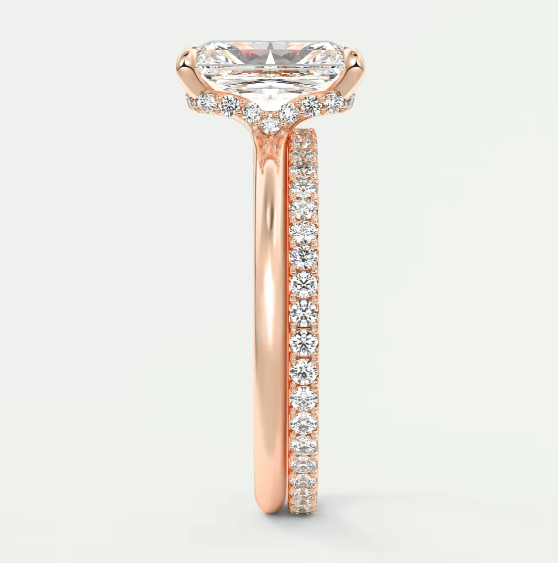 18-karat rose gold engagement ring with a princess-cut diamond and pave-set diamonds on the band.