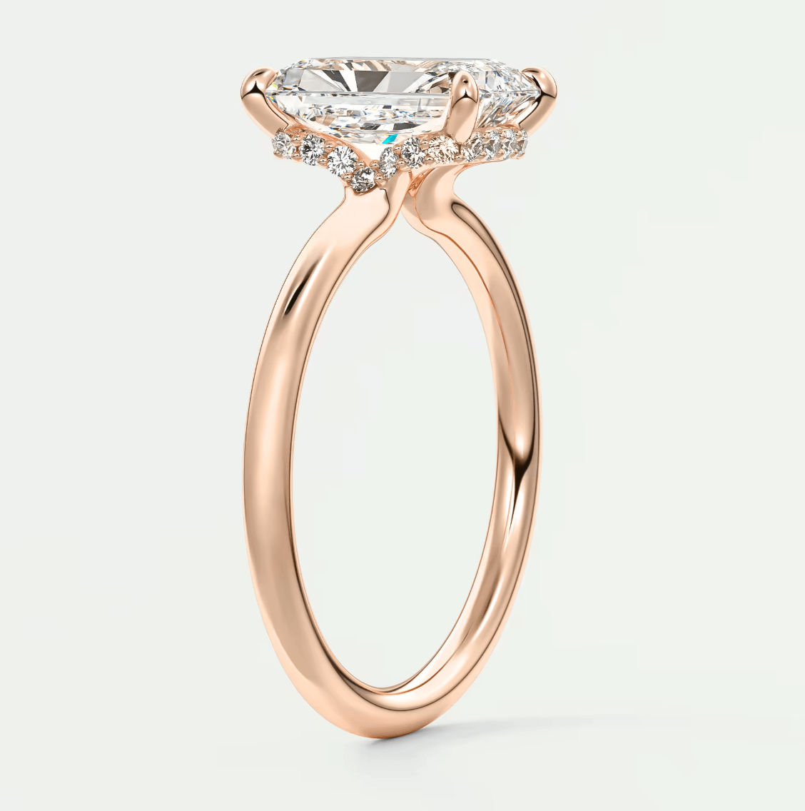 Rose gold engagement ring with a princess cut diamond and halo design.
