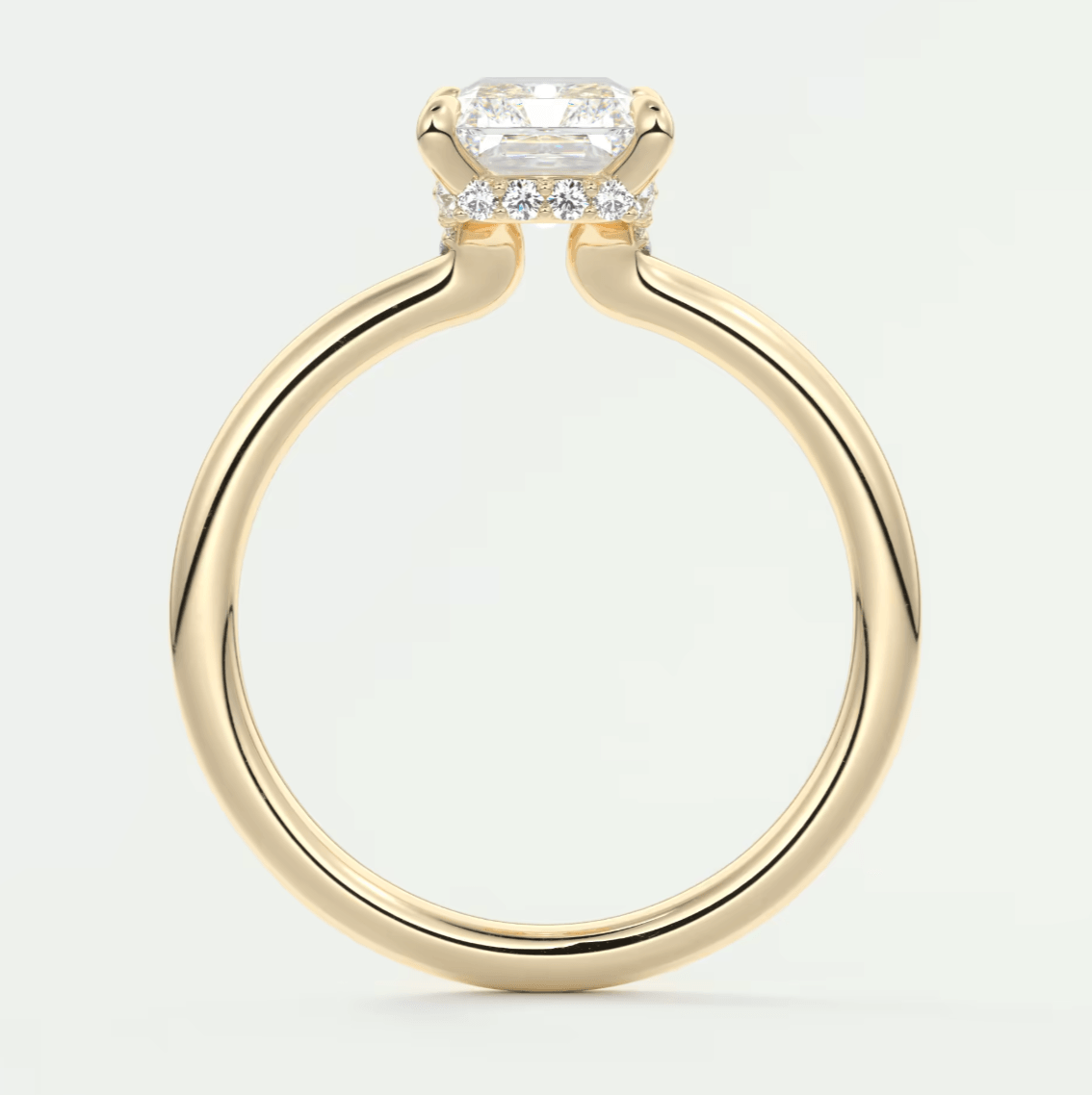 18k yellow gold engagement ring with a cushion-cut diamond and small side diamonds.