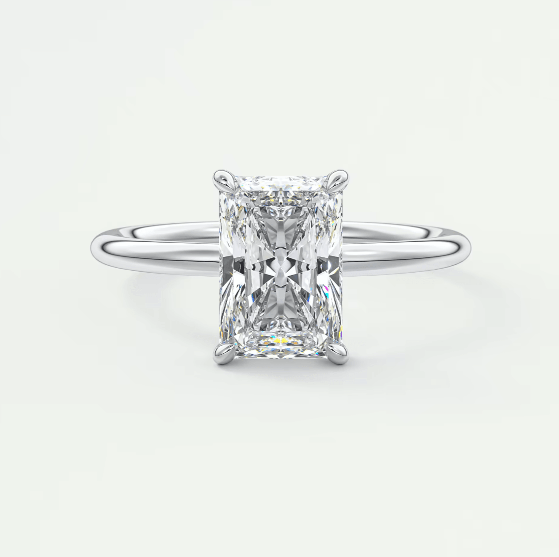18-karat white gold engagement ring with a radiant cut diamond.