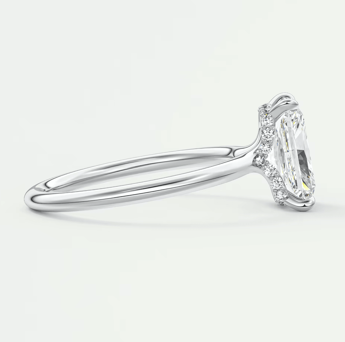 18k white gold engagement ring with marquise-cut diamond and halo design.