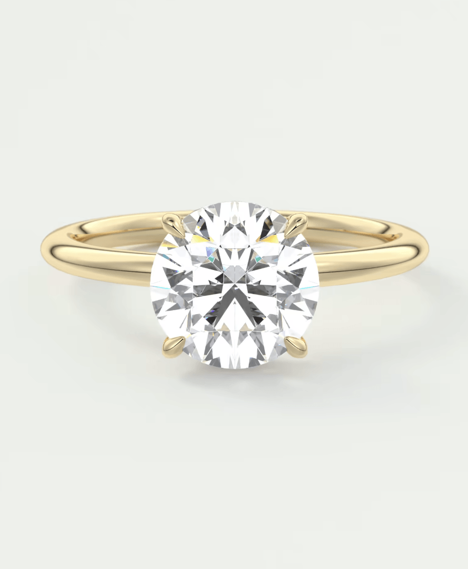 18-karat yellow gold solitaire diamond engagement ring with a round brilliant cut gemstone.
