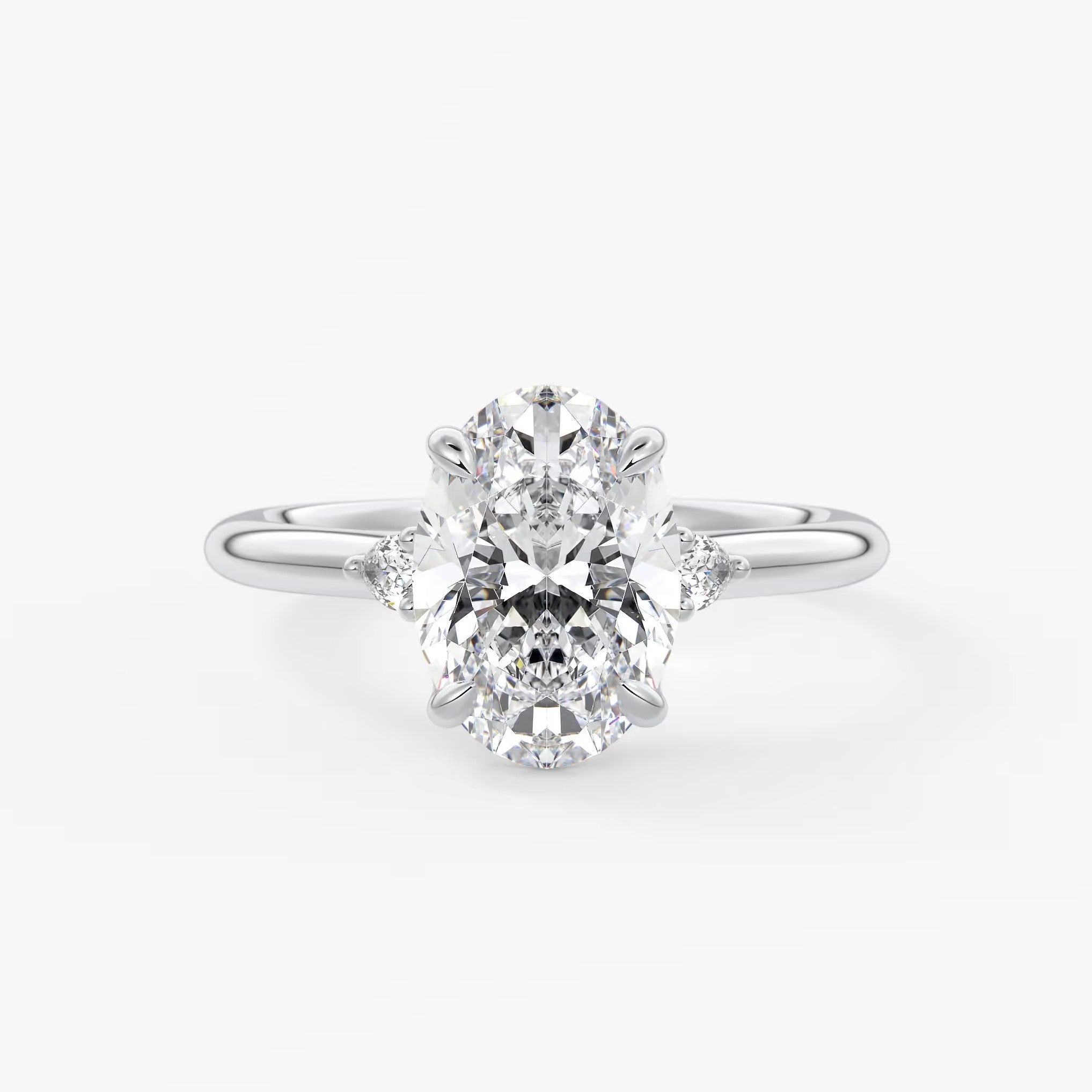 Cassia – oval trilogy with pear side stones