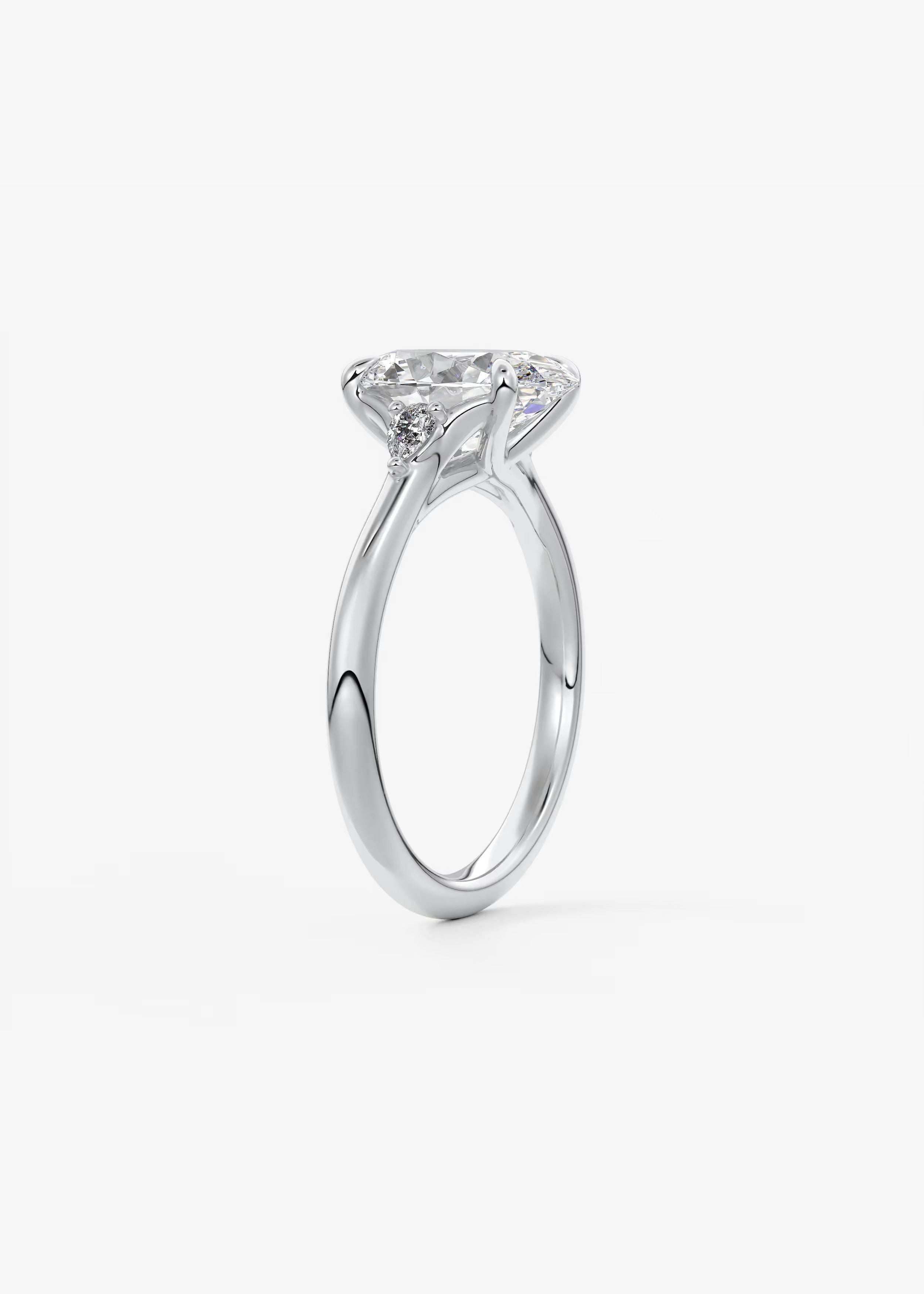 Cassia – oval trilogy with pear side stones