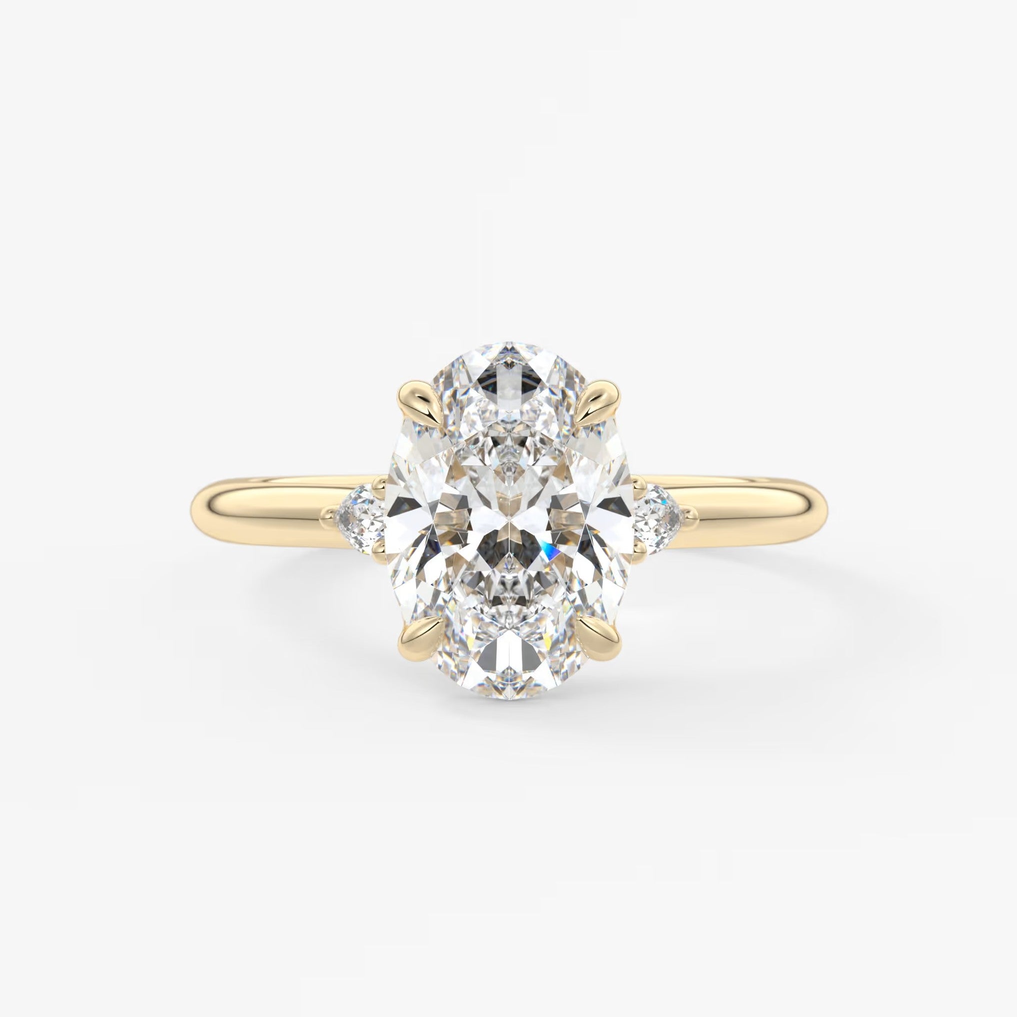 Cassia – oval trilogy with pear side stones