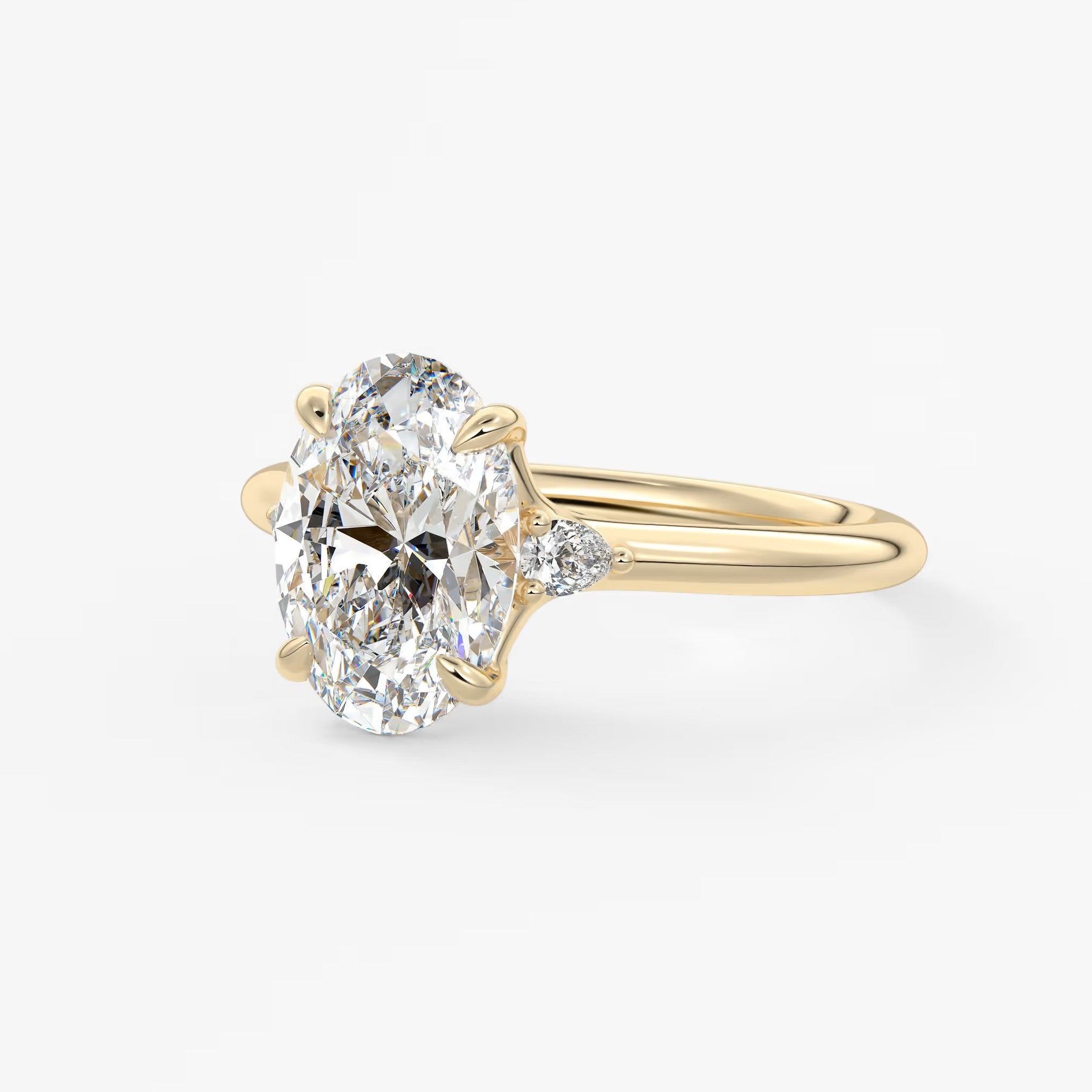 Cassia – oval trilogy with pear side stones