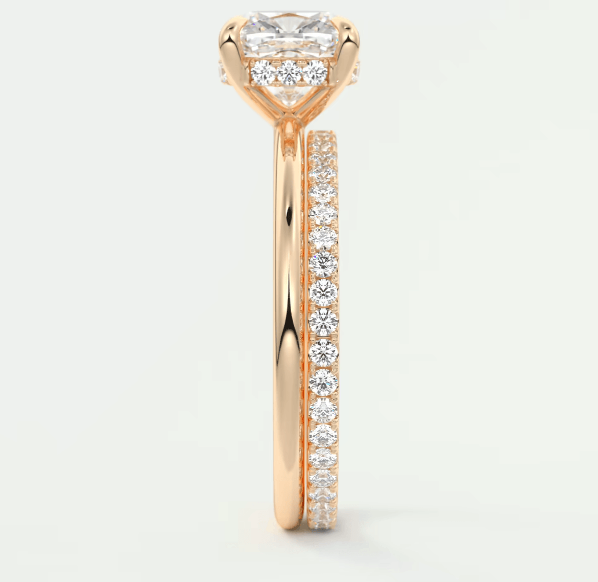 18k rose gold engagement ring with princess cut diamond and pave set diamonds on band.