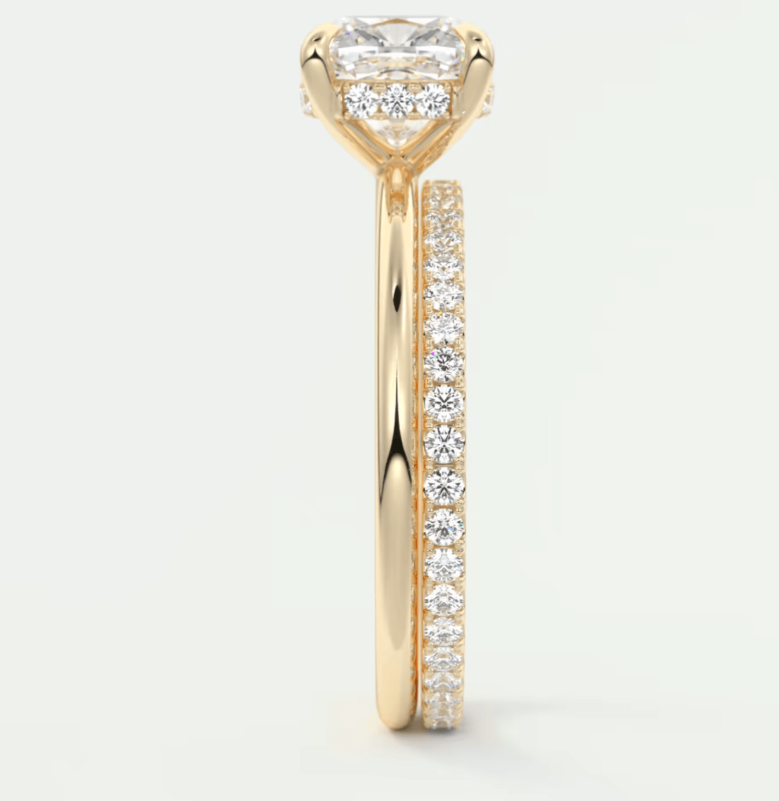 18k yellow gold engagement ring with princess cut diamond and pave set diamonds on band.