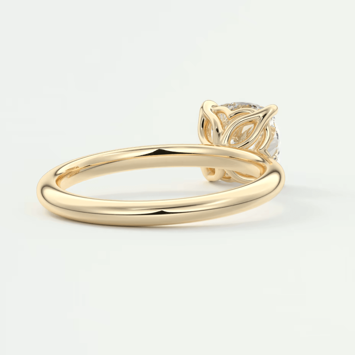 18k yellow gold engagement ring with a diamond center stone and leaf-inspired band design.