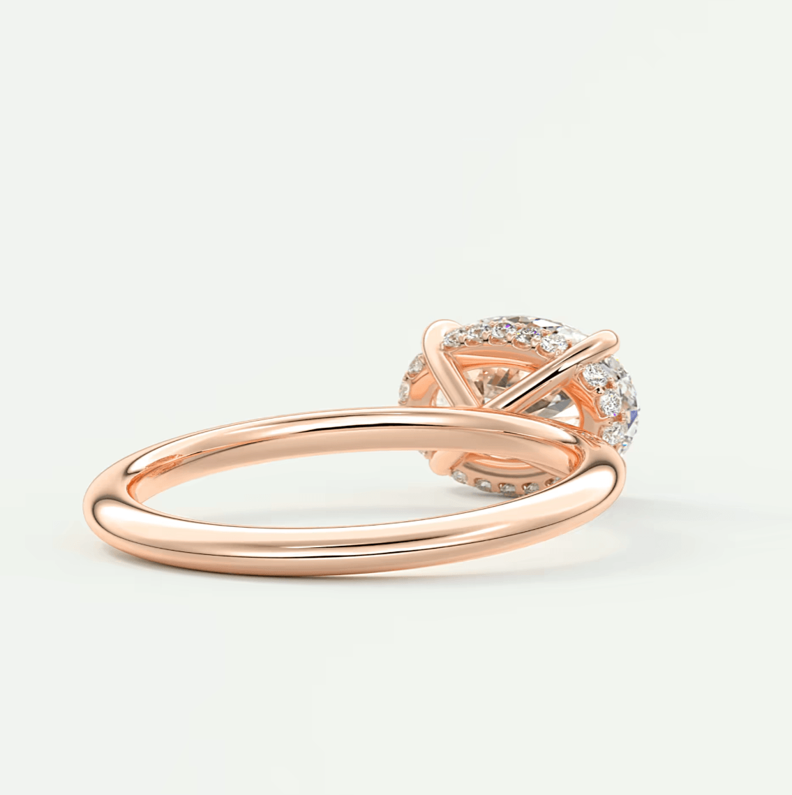 Rose gold diamond engagement ring with intricate knot design and halo of smaller diamonds