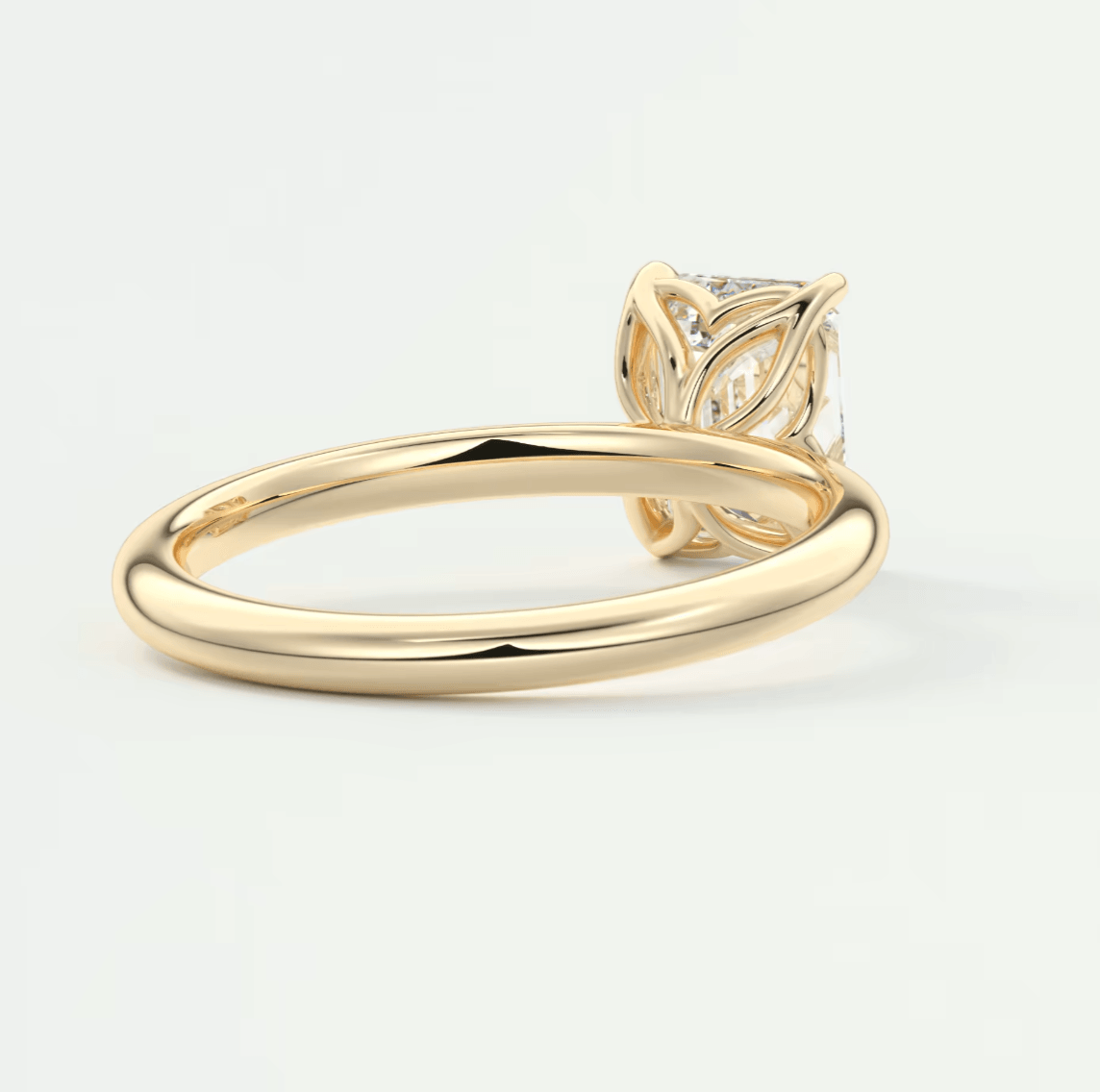 18-karat yellow gold engagement ring with a leaf-inspired design and diamond center stone.