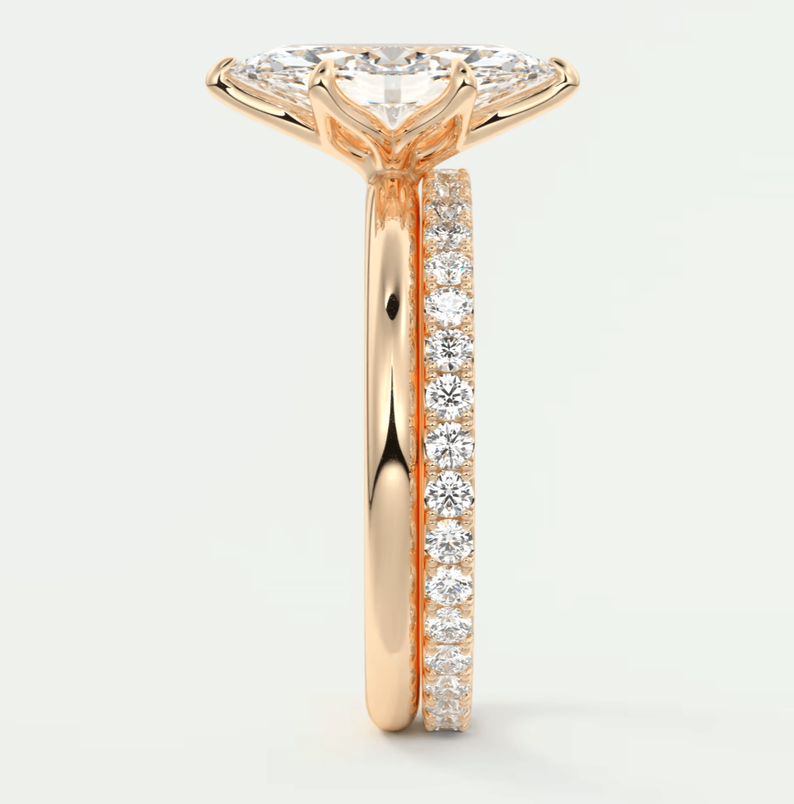 18-karat rose gold diamond engagement ring with a princess-cut center stone and pavé set diamonds on the band.