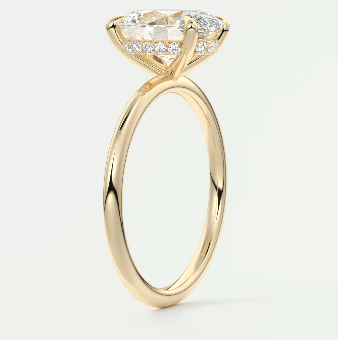 18k yellow gold engagement ring with a marquise-cut diamond and pave set side stones.