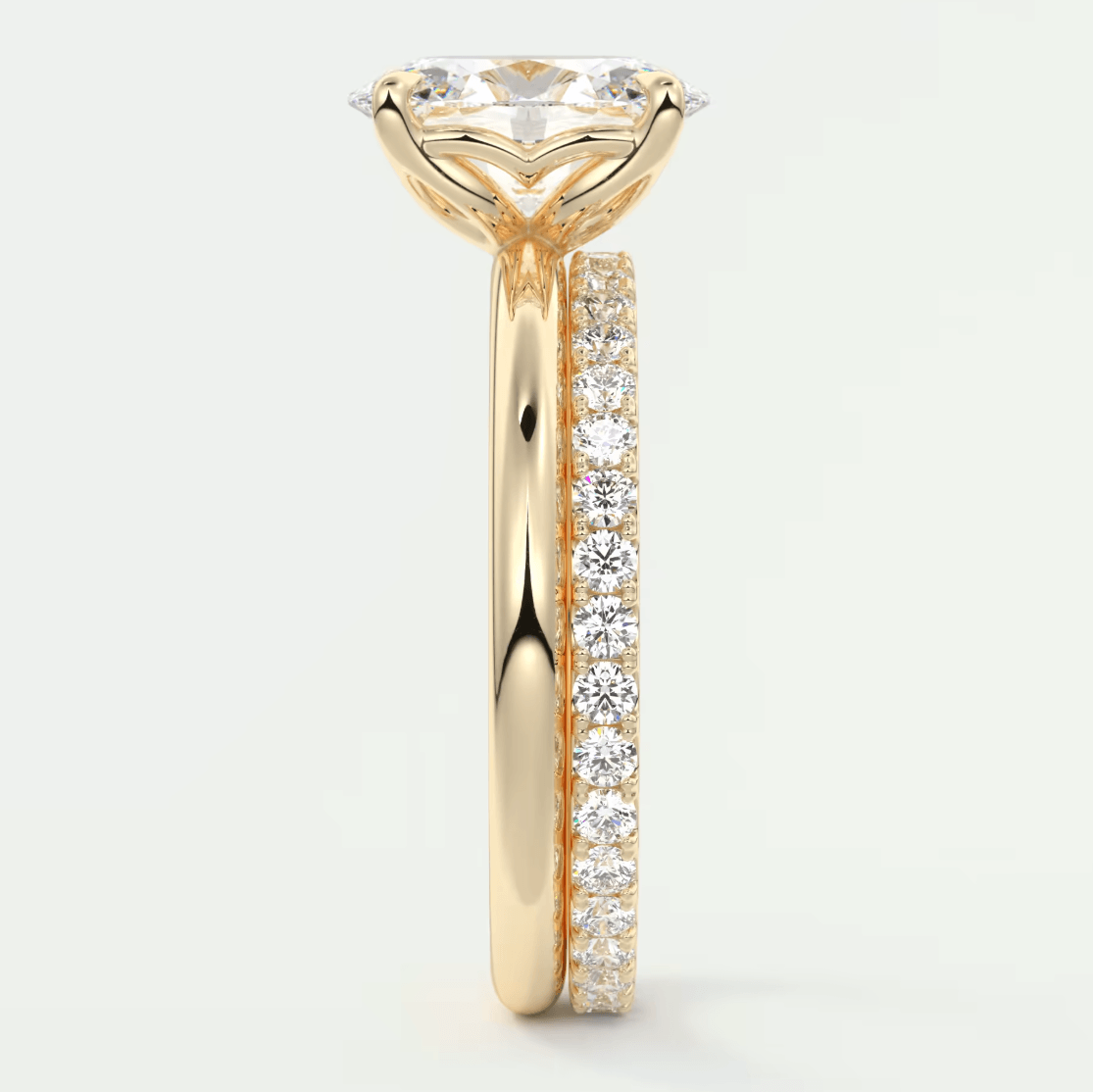 18k yellow gold engagement ring with a round diamond center and pave set diamonds on the band.