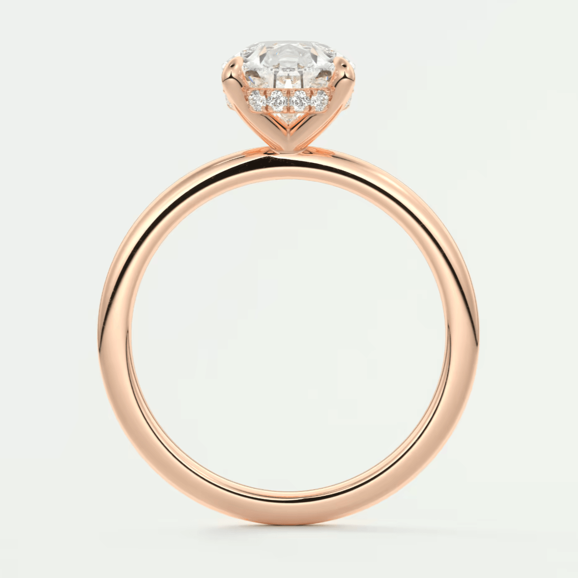 Rose gold diamond engagement ring with a halo design and small diamonds on the band.