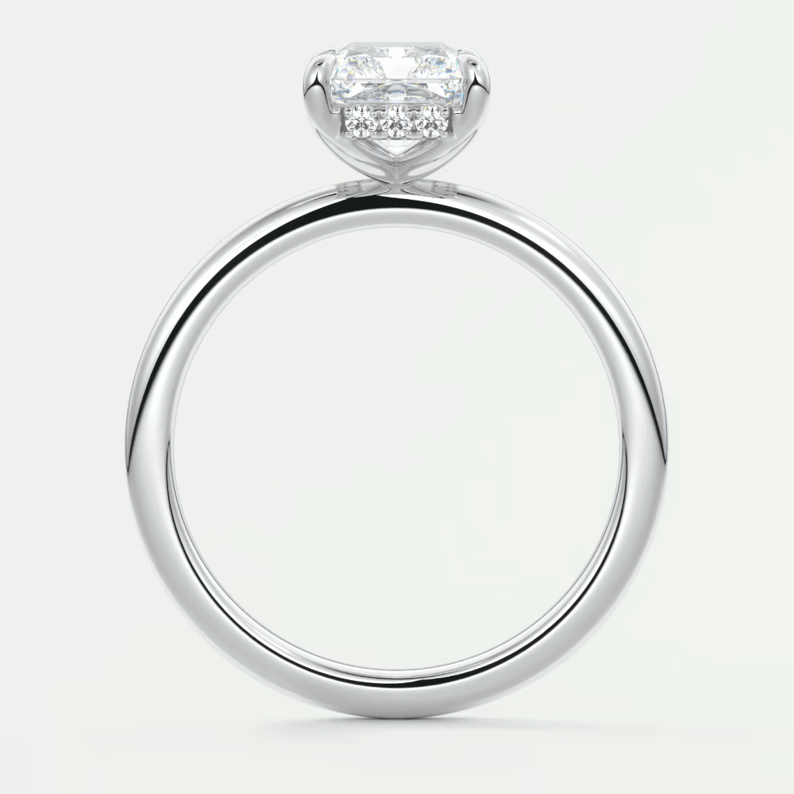 18k white gold diamond engagement ring with a cushion-cut center stone and pavé set diamonds on the band.